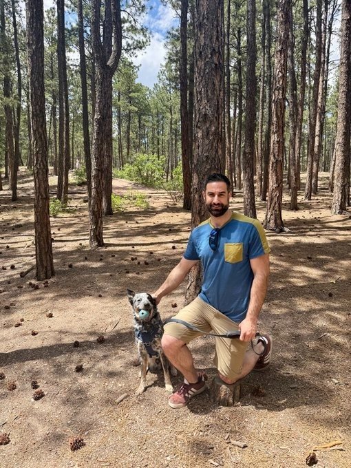 Ross Metler kneeling with his running mate, Indie, in Colorado.